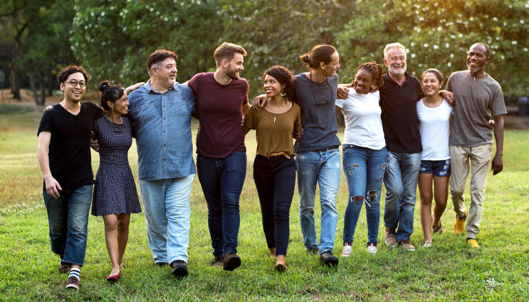 Community of people walking in nature.