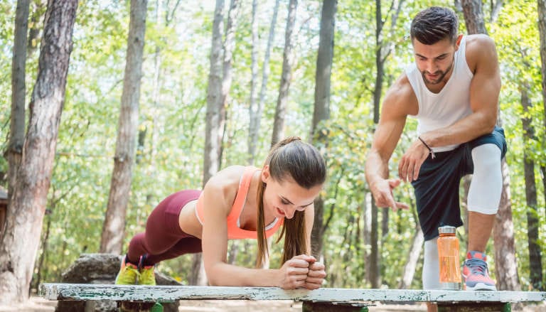 A couple exercising core muscles.