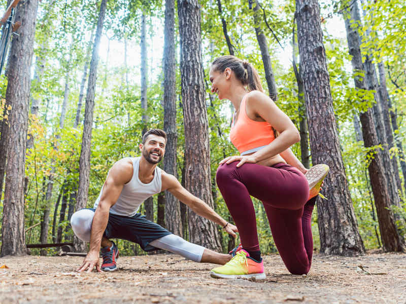 Couple Stretching in a Forest