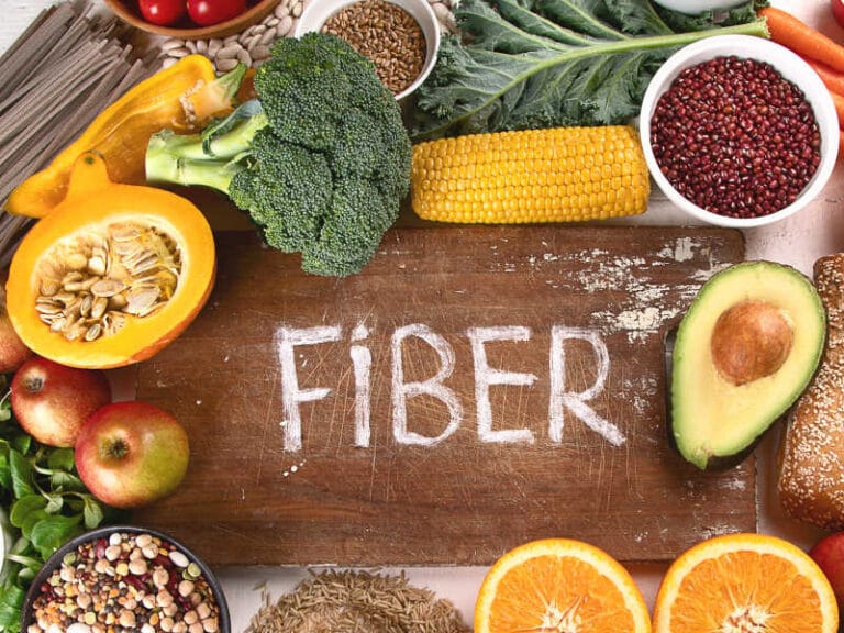 Fiber-rich foods on a wooden surface.