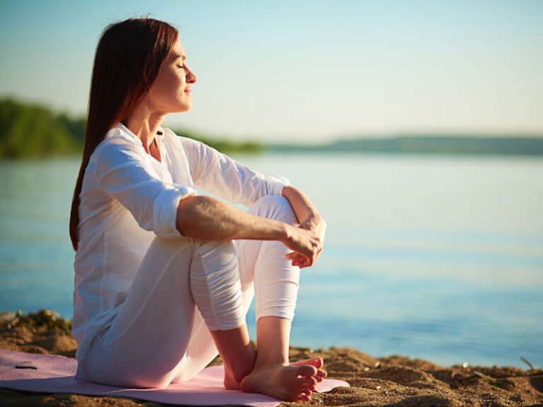 Woman Sitting Happy by a Lake