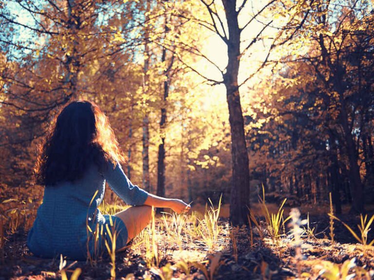 Woman Meditating in a Forest